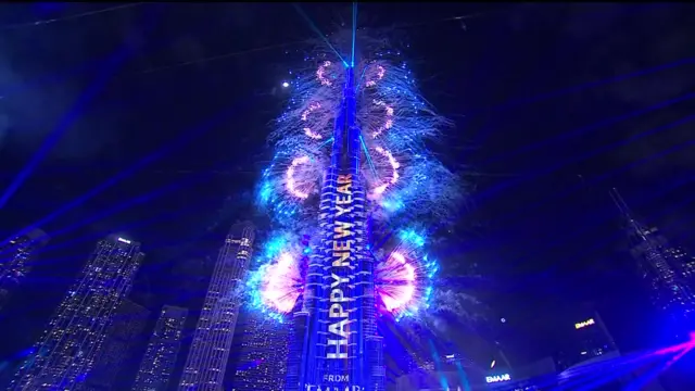 Fireworks in Dubai, text on building reads Happy New Year.