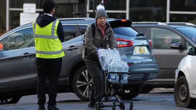 Bottled water is taken away from Tunbridge Wells Sports Centre.