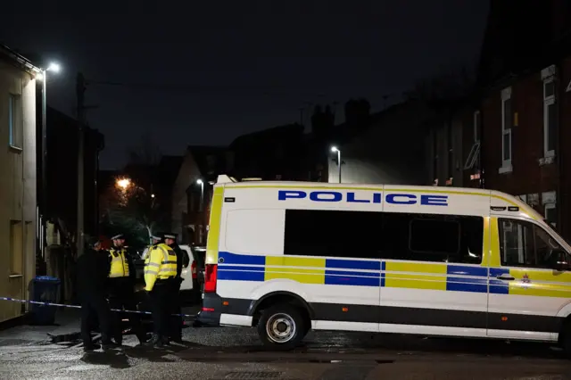 Police van outside cordoned street in Derby