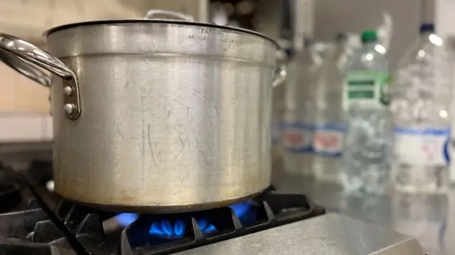 A pan of water boiling on a gas hob