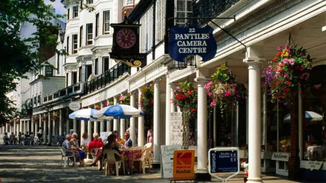 The Pantiles in Tunbridge Wells. People are sitting outside.