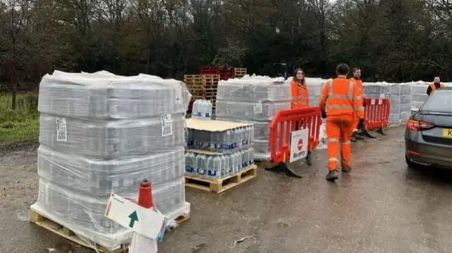 A water station with pallets of water.