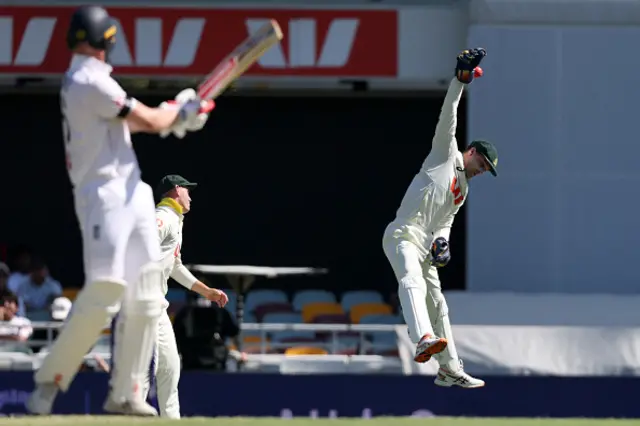 Australian wicketkeeper Alex Carey tries to field a short-pitch delivery on day one