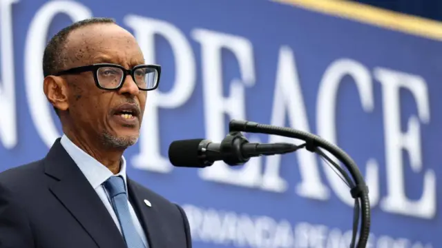 Rwandan President Paul Kagame speaks at a lectern.