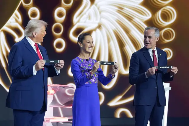 US President Donald Trump, Mexico's President Claudia Sheinbaum and Canada's Prime Minister Mark Carney pose with their cards during the draw for the 2026 FIFA Football World Cup taking place in the US, Canada and Mexico, at the Kennedy Center, in Washington, DC, on December 5, 2025.