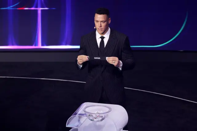 Aaron Judge draws Qatar from pot 3 during the 2026 FIFA World Cup draw at the John F. Kennedy Center for the Performing Arts, Washington, United States.
