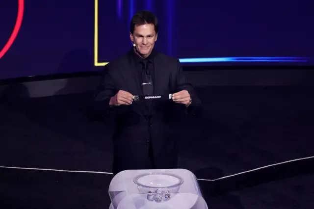 Tom Brady draws Germany from pot 1 during the 2026 FIFA World Cup draw at the John F. Kennedy Center for the Performing Arts, Washington, United States. Picture date: Friday December 5, 2025. PA Photo.