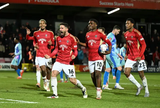 Salford players celebrate Fabio Borini's goal to make it 3-0 against Leyton Orient