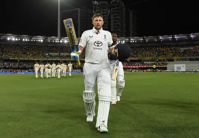 Joe Root salutes the crowd after leaving the field at the Gabba