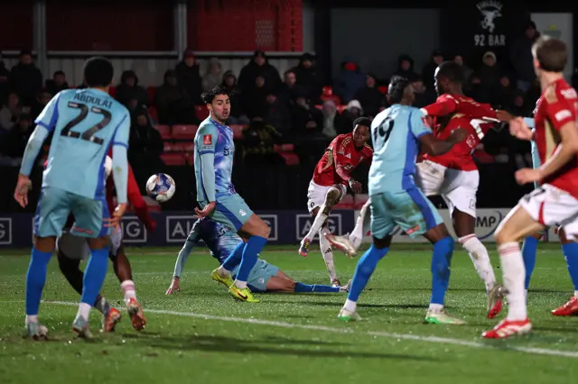 Kallum Cesay shoots for the second Salford goal against Orient