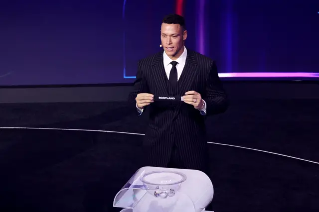 Aaron Judge draws Scotland from pot 3 during the 2026 FIFA World Cup draw at the John F. Kennedy Center for the Performing Arts, Washington, United States. Picture date: Friday December 5, 2025. PA Photo.