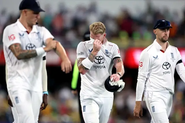 England's captain Ben Stokes (C) reacts with teammates