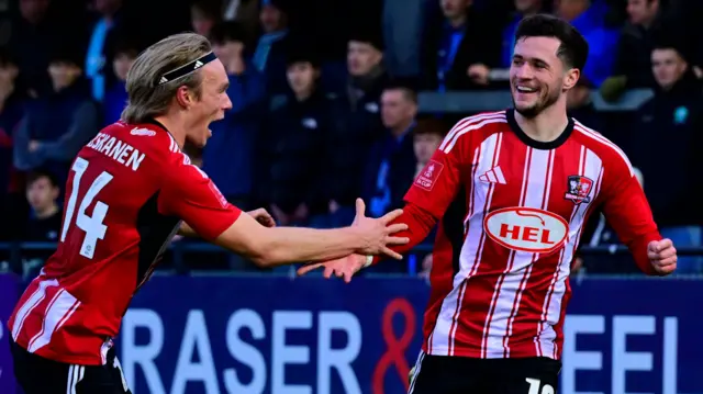 Jack Aitchison celebrates giving Exeter the lead against Wycombe
