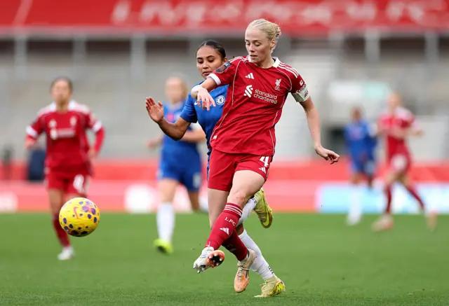 Grace Fisk of Liverpool passes the ball under pressure from Alyssa Thompson of Chelsea during the Barclays Women's Super League match between Liverpool and Chelsea FC at The St Helens Stadium on November 16, 2025 in St Helens, England.