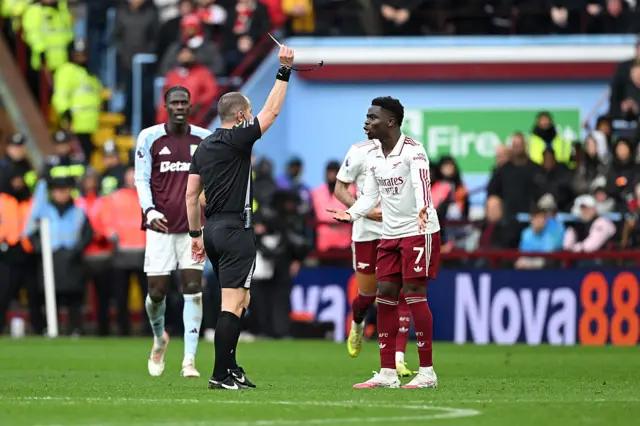 Bukayo Saka goes into the book for a foul on Ian Maatsen