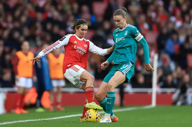 Mariona Caldentey of Arsenal is challenged by Jenna Clark of Liverpool during the Barclays Women's Super League match between Arsenal and Liverpool at Emirates Stadium on December 06, 2025 in London, England.