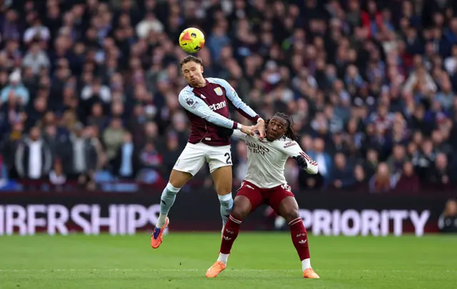 Matty Cash of Aston Villa wins a header against Eberechi Eze of Arsenal