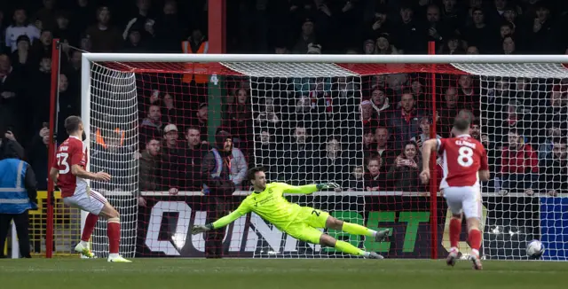 Aaron Drinan scores for Swindon from the penalty spot against Bolton