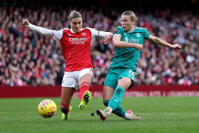Beata Olsson of Liverpool scores her team's first goal whilst under pressure from Steph Catley of Arsenal during the Barclays Women's Super League match between Arsenal and Liverpool at Emirates Stadium on December 06, 2025 in London, England.