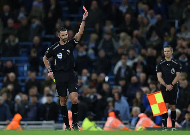 Referee holding up a red card