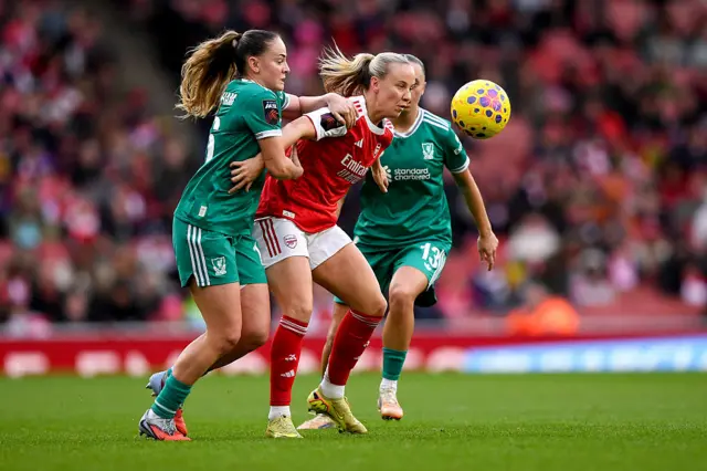 Beth Mead of Arsenal is challenged by Lily Woodham and Mia Enderby of Liverpool during the Barclays Women's Super League match between Arsenal and Liverpool at Emirates Stadium on December 06, 2025 in London, England.