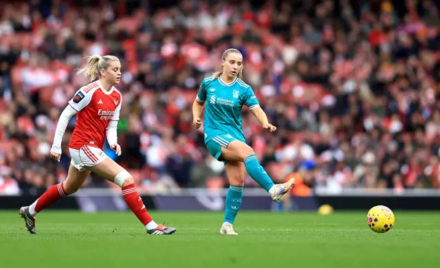 Kirsty MacLean of Liverpool passes the ball whilst under pressure from Alessia Russo of Arsenal during the Barclays Women's Super League match between Arsenal and Liverpool at Emirates Stadium on December 06, 2025 in London, England.