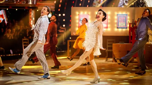 Amber and Nikita with dancers on stage