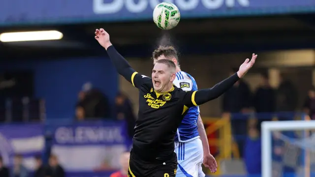 Ben Arthurs heads the ball