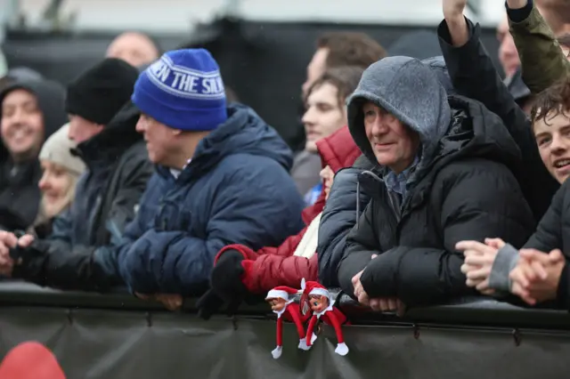 Two of Santa's elves are in the crowd watching Slough v Macclesfield