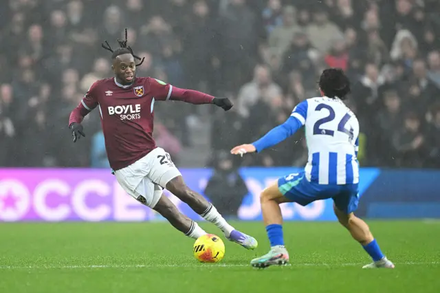 Aaron Wan-Bissaka of West Ham United takes on Ferdi Kadioglu of Brighton & Hove Albion during the Premier League match between Brighton & Hove Albion and West Ham United at Amex Stadium on December 07, 2025 in Brighton, England.