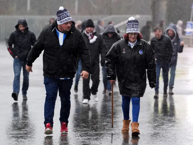 Brighton fans in the rain