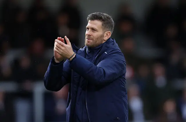 Boreham Wood boss Luke Garrard claps the fans