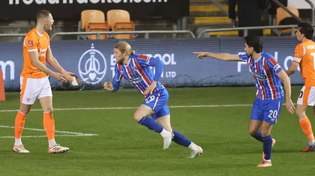 Carlisle's Luke Armstrong celebrates pulling a goal back at Blackpool