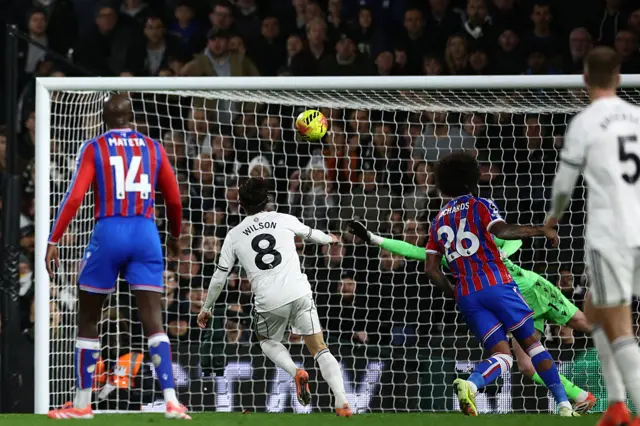 Fulham's Welsh midfielder #08 Harry Wilson (C) scores their first goal during the English Premier League football match between Fulham and Crystal Palace at Craven Cottage in London on December 7, 2025.