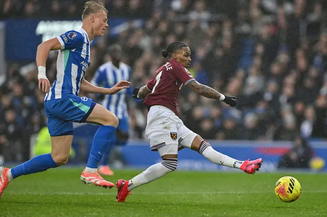West Ham United's Dutch striker #07 Crysencio Summerville (R) takes a shot as Brighton's Dutch defender #06 Jan Paul van Hecke (L) defends during the English Premier League football match between Brighton and Hove Albion and West Ham United at the American Express Community Stadium in Brighton, southern England on December 7, 2025.