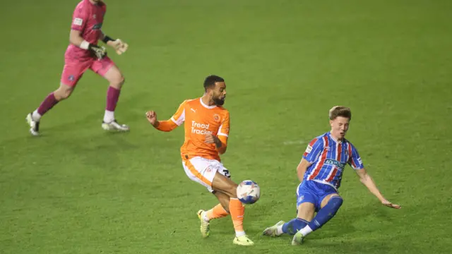 Blackpool's CJ Hamilton is denied by Hayden Atkinson