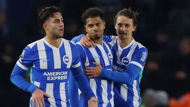 Brighton & Hove Albion's Georginio Rutter celebrates scoring their first goal with Charalampos Kostoulas and Olivier Boscagli