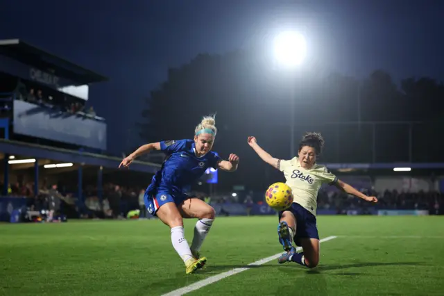 Ellie Carpenter of Chelsea crosses the ball whilst under pressure from Honoka Hayashi of Everton during the Barclays Women's Super League match between Chelsea FC and Everton at Kingsmeadow on December 07, 2025