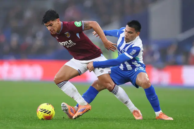 Mateus Fernandes of West Ham United is challenged by Diego Gomez of Brighton & Hove Albion during the Premier League match between Brighton & Hove Albion and West Ham United at Amex Stadium on December 07, 2025 in Brighton, England.