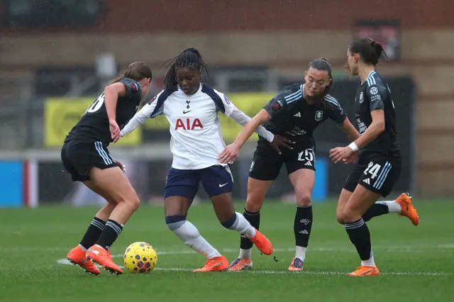 Jessica Naz of Tottenham Hotspur is challenged by Rachel Maltby, Miri Taylor and Oceane Deslandes of Aston Villa during the Barclays Women's Super League match between Tottenham Hotspur and Aston Villa at BetWright Stadium on December 07, 2025 in London