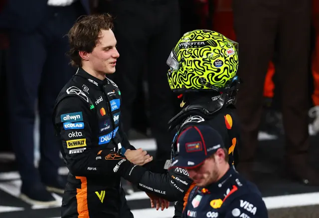 Oscar Piastri shakes Lando Norris' hand after the Abu Dhabi Grand Prix