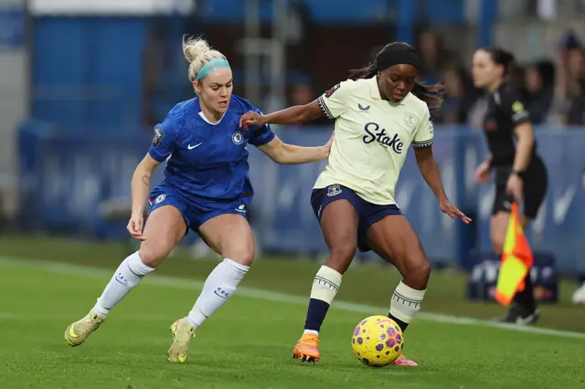 oni Payne of Everton is challenged by Ellie Carpenter of Chelsea during the Barclays Women's Super League match between Chelsea FC and Everton at Kingsmeadow on December 07, 2025 in Kingston upon Thames, England.