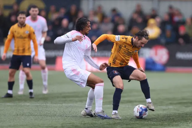 Macclesfield's D'Mani Mellor (left) and Slough Town's Johnny Goddard battle for the ball during the FA Cup second round match at Arbour Park