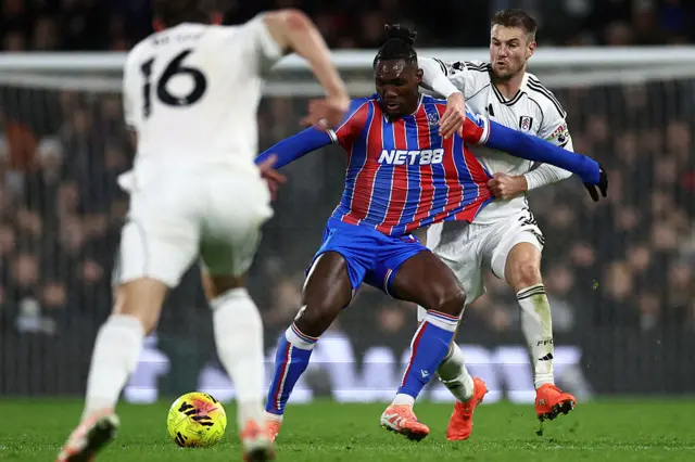 Fulham's Danish defender #05 Joachim Andersen (R) fouls Crystal Palace's Nigerian midfielder #12 Christantus Uche (C) during the English Premier League football match between Fulham and Crystal Palace at Craven Cottage in London on December 7, 2025.