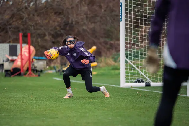 Tullis-Joyce wears a protective mask during training