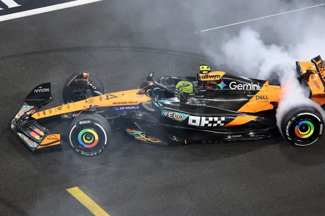 Lando Norris does donuts on the Abu Dhabi track after winning the title