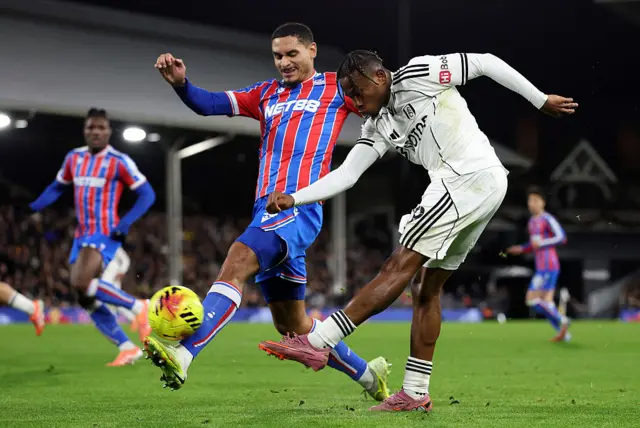 Samuel Chukwueze of Fulham missed a chance as he takes a shot whilst under pressure from Maxence Lacroix of Crystal Palace during the Premier League match between Fulham and Crystal Palace at Craven Cottage on December 07, 2025 in London, England.
