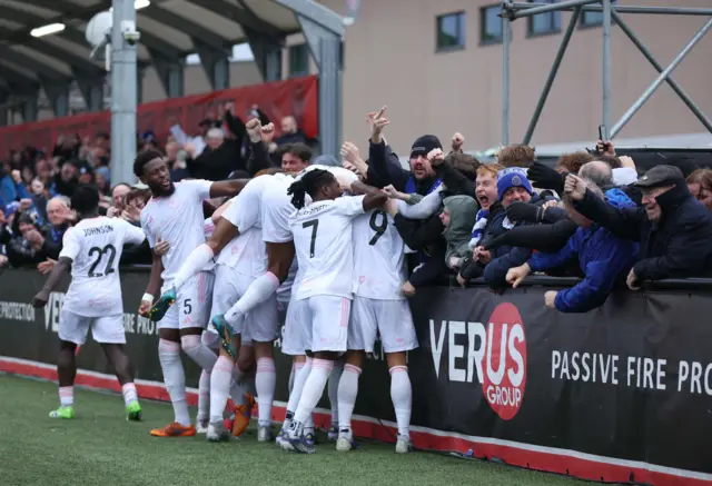 Macclesfield players celebrate with their fans at Slough