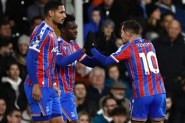 Crystal Palace's English striker #09 Eddie Nketiah (2L) celebrates with Crystal Palace's Spanish midfielder #10 Yeremy Pino (R) after scoring the opening goal of the English Premier League football match between Fulham and Crystal Palace at Craven Cottage in London on December 7, 2025.