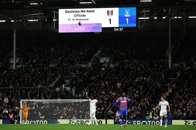 The big screen displays the result of a VAR (Video Assistant Referee) review disallowing a Fulham goal for an offside in the build-up during the English Premier League football match between Fulham and Crystal Palace at Craven Cottage in London on December 7, 2025.
